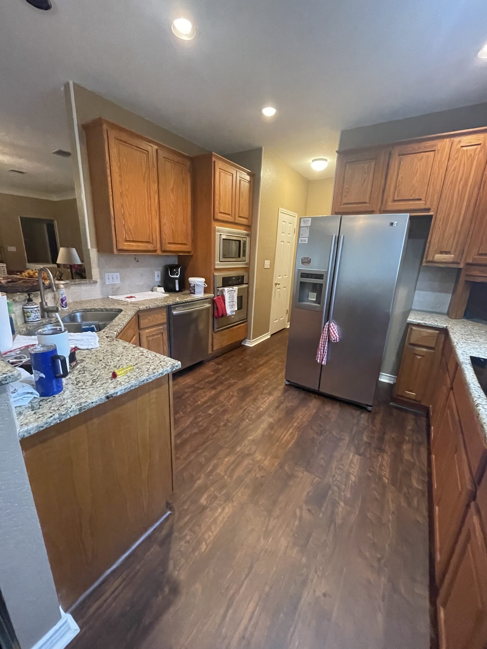 Kitchen before, honey oak cabinets around the sink and oven wall