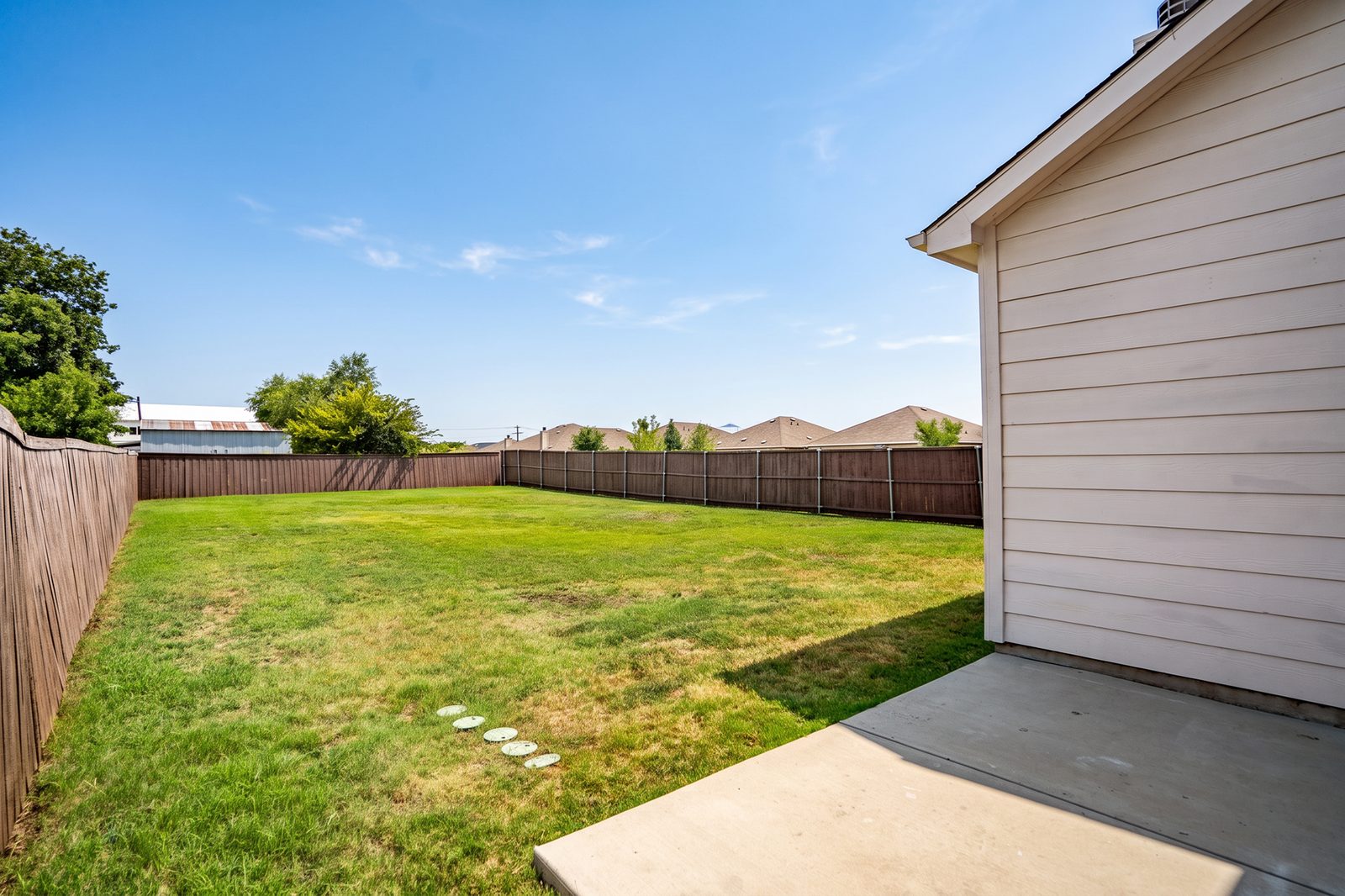 The same patio, a bare concrete slab
